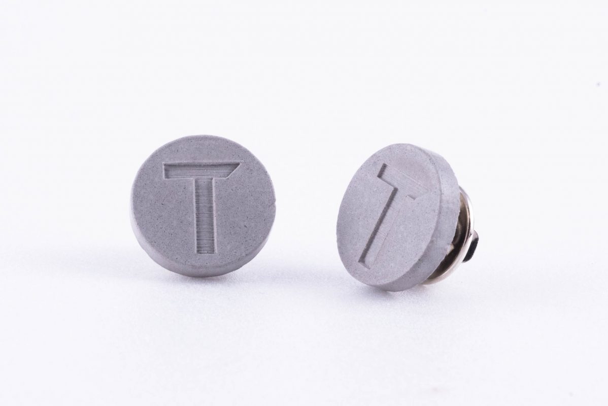 Branded concrete pins for construction company employees